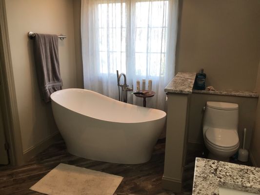 Fully remodeled bathroom that removed drop in soaking tub and installed a sleek free standing slipper tub.