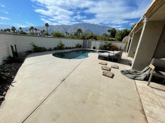 BEFORE! Ugly concrete deck, leak between the pool/spa, pool border tiles coming loose.