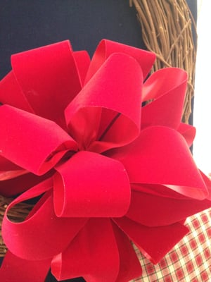 Hand tied, resilient red felt holiday bows.