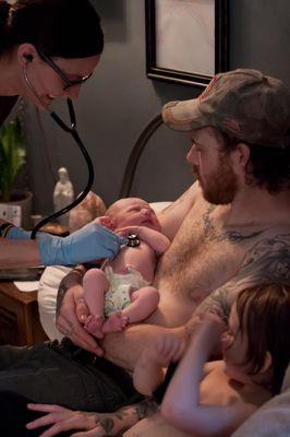 Rebecca Burkett, Midwife, checking vitals on this fresh baby right after her birth at home.