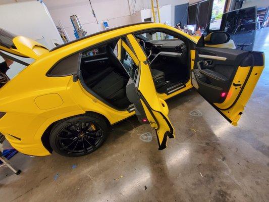 Lamborghini Urus total transformation from glossy black paint to Satin Yellow. All surfaces wrapped in and out!