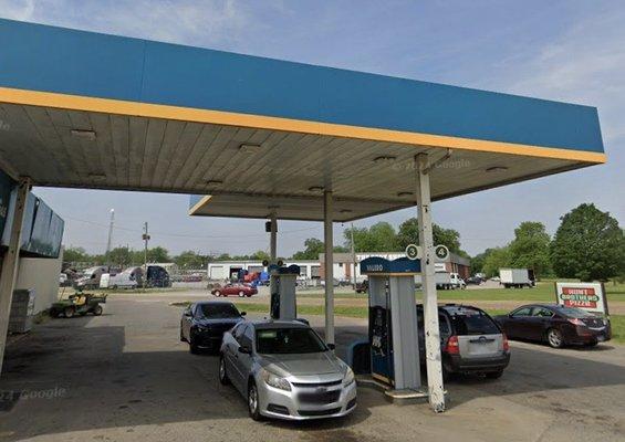 view of gasoline pumps, facing westward