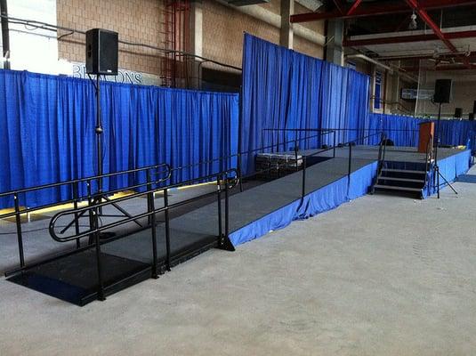 Stage Rental with stairs, ramp, skirting and backdrop.  http://www.camelotspecialevents.com/StageRental.htm