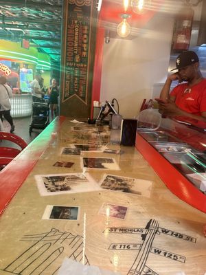 The counter needs to be cleaned, but the staff would rather be on their phone.