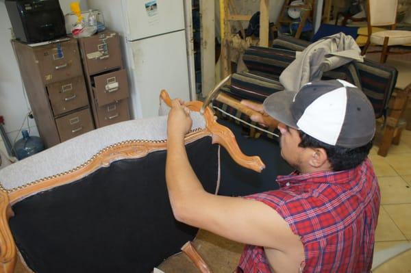 Henrry C. (Employee). Fixing a chair at Pacific Palisades Upholstery Shop.