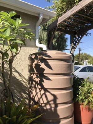 Bushman Water Tank, 205 gallons, 3" round downspout secured to wall.