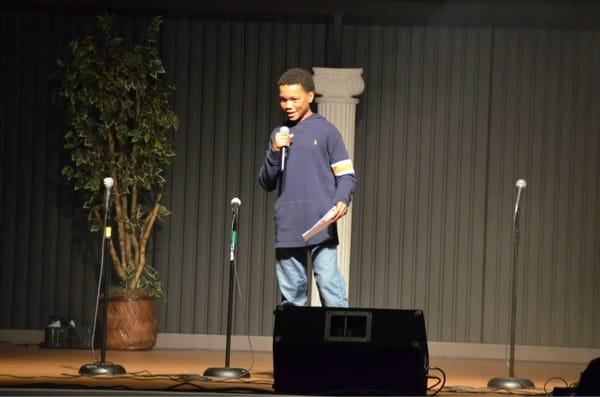 Young man delivering spoken word during a youth event in the family life center.