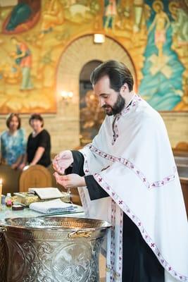 blessing a necklace. photo from a recent christening. www.garberophotography.com