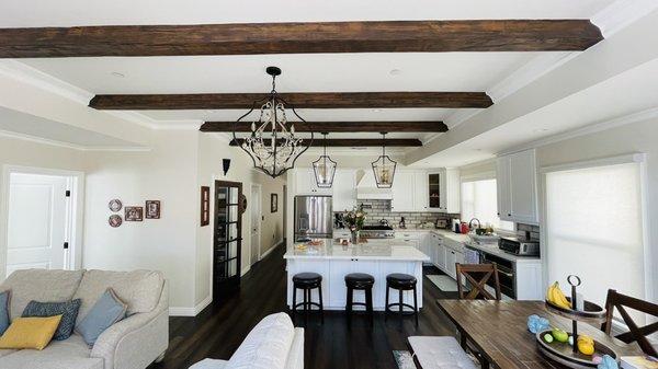 Wood beams with drop ceiling on the sides with crown moldings