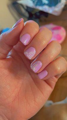 Beautiful done light purple real nails with the cutest little daisies painted on!