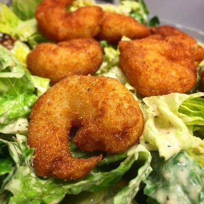 Caesar Salad topped with our Breaded Buffalo Shrimp