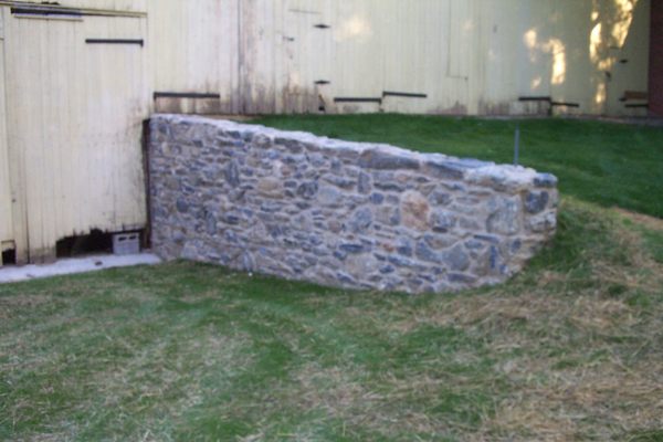 Limestone barn wall.