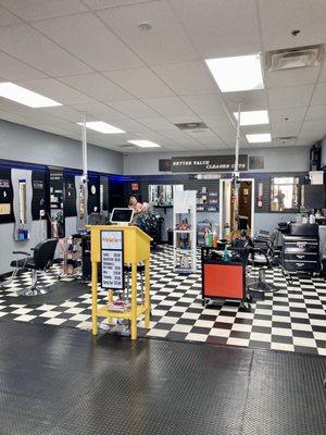 View from waiting area of stylists and barber area