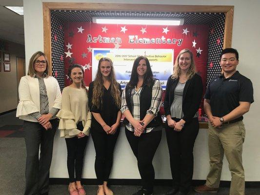 The Synergy Team participates in United Way's Day of Caring by distributing gift bags to local elementary schools.