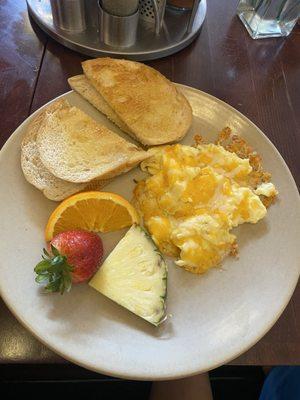 Kids scrambled eggs & cheese sourdough & fruit garnish. $7, kid approved!