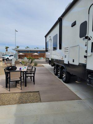 The patio of our site directly across the "comfort station" which has their playground