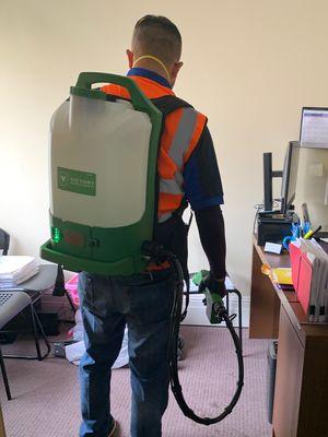 Our team providing backpack electrostatic disinfecting at an office