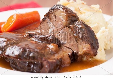 Braised roast beef w/ garlic mashed potatoes and glazed carrots.