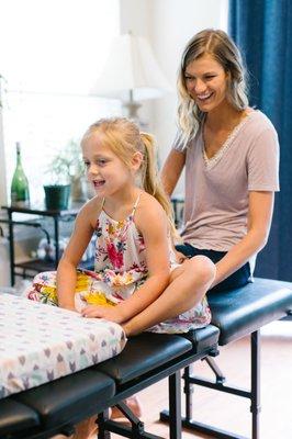 Dr. Brittany adjusting a little girl.