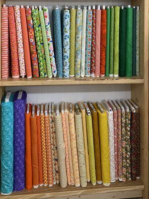 One of many shelves full of bolts of fabric and backing!!