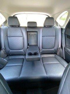 This 2024 Kia Seltos boasts spacious black leather back seats, ideal for easy cleaning and luxurious comfort. Enjoy crystal-clear audio.