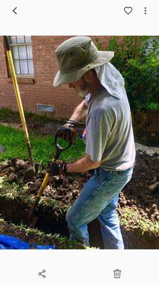 Trenching for the discharge drain line for area and downspout drains.