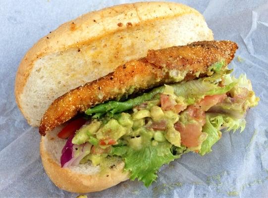 Fried tilapia sandwich with guacamole.