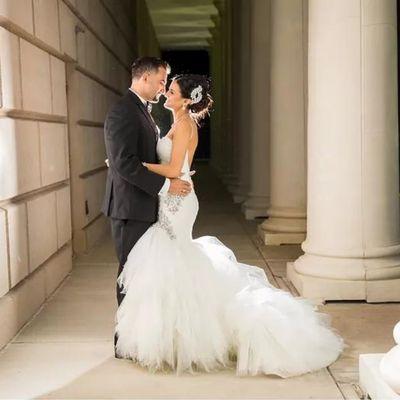 Couple sharing a moment by the grand columns that are part of our covered entrance.