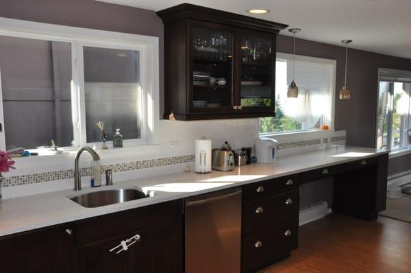 A contemporary look with a huge amount of counter space and light in this remodeled kitchen.