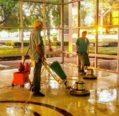 Mary minnick and buddy turney scrubbing Bakersfield college library floors and refinishing them.