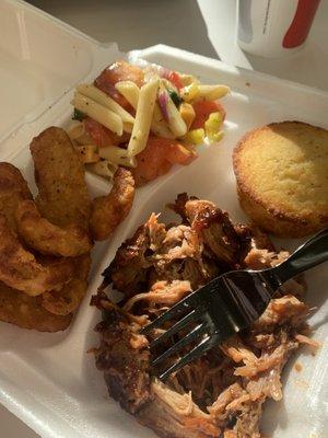 Entree and two sides with cornbread. Bbq, onion petals, pasta salad.