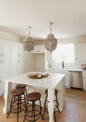 Kitchen renovation with new counters and light fixtures.