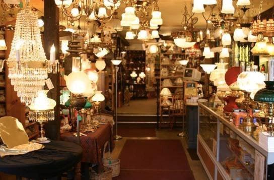 The warm glow of antique and reproduction lighting greets you in the front showroom of Johnsons Lamp Shop.