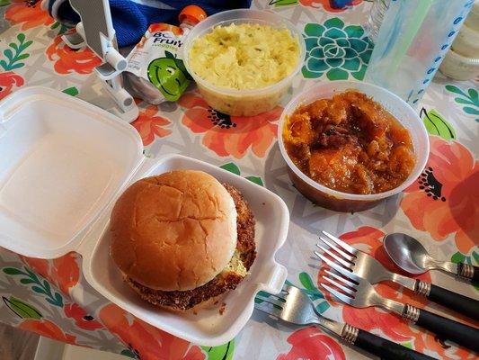 Crab cake, candied yams, and potato salad