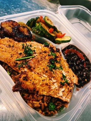 Garlic salmon plate with fresh veggies, black beans, peas & rice, and plantains