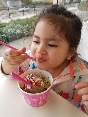 Kikay feelin' her cold ass ice cream with gummy bear and sprinkles toppings.