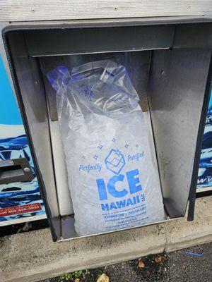 The bag of ice slides out from a chute