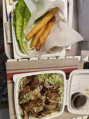 Vietnamese salad with grilled chicken and egg rolls