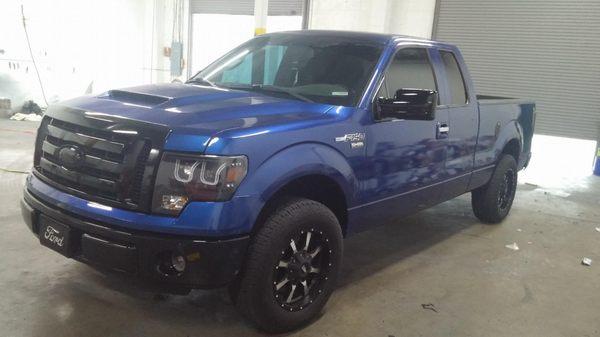 Royal Blue with gloss and black accents (mirrors, grill, bumpers, and wheels).