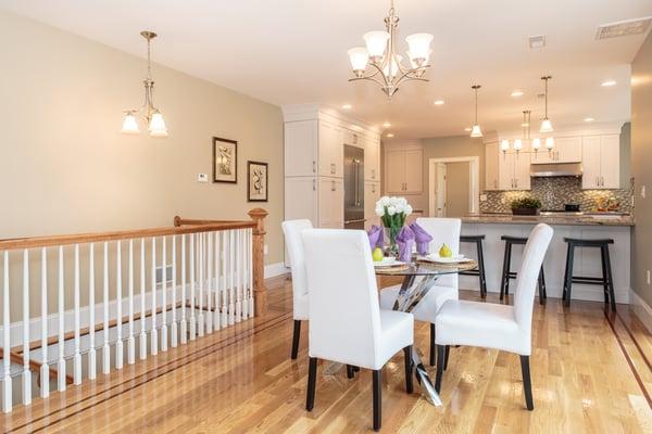 Open concept kitchen with center island. abundant storage, high-end appliances. Glass tile backsplash complemented by granite countertops.