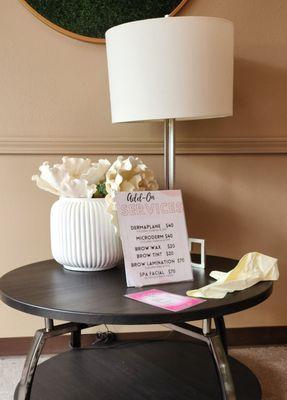 Trash bag on lobby table next to pricing sheet.