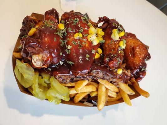 Hook em- fries, pulled pork, honey bbq wings topped with corn, and pickles