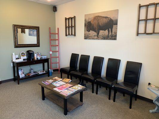 Cozy waiting room, with coffee and water on hand