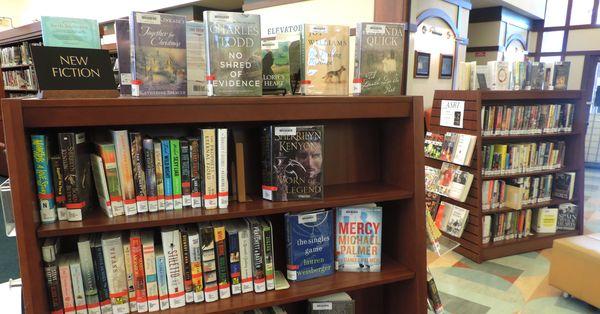 New books and bestsellers are displayed near the circulation desk.