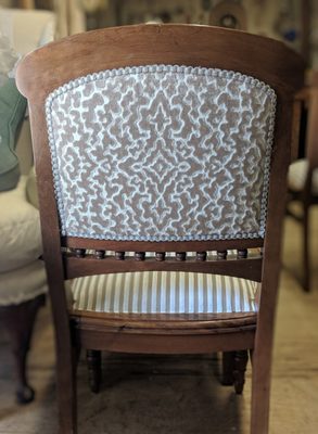 Chair back covered in a cut velvet fabric.