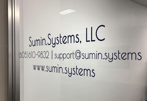 Sumin.Systems, LLC window lettering.