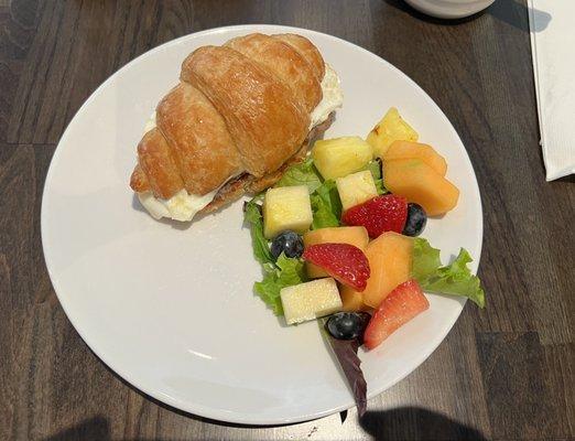 Croissant sandwich with side of fruit