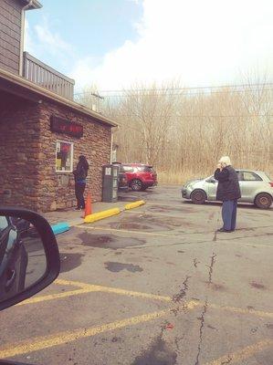 Waiting in line for smokes after having filled gas tank.  The drive-thru window had really long line.