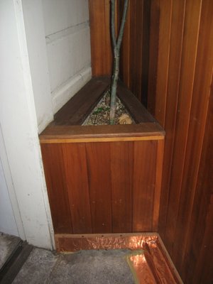 Close-up of custom-made, cedar planter with copper flashing at the base.