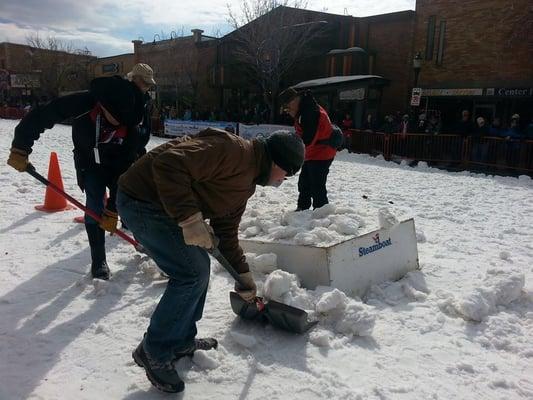 Robert Yazbeck- Managing Director of Coldwell Banker Distinctive Properties helping shovel snow onto one of the jumps for Winter Carnival